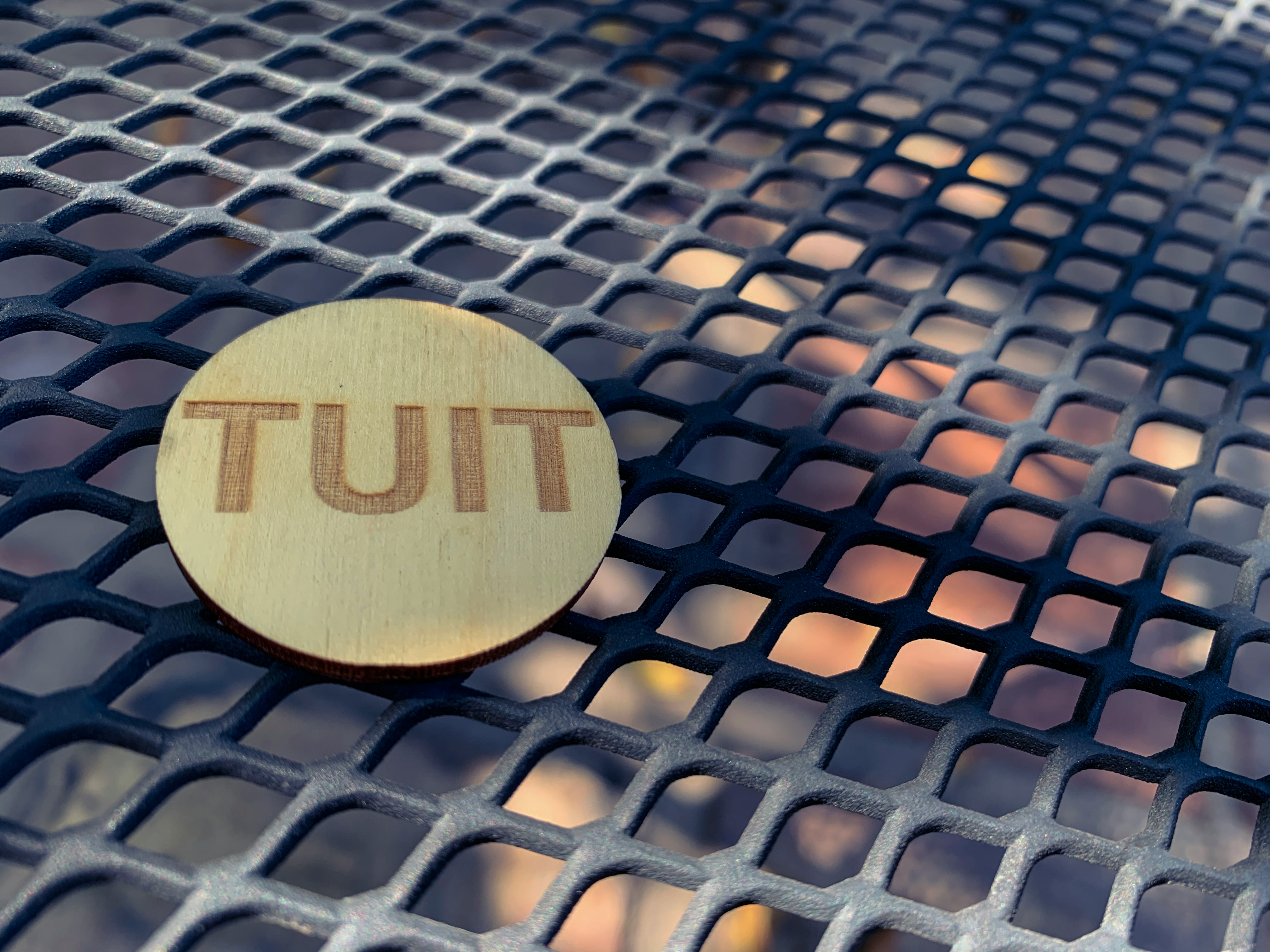 brown wooden round board on black metal mesh table